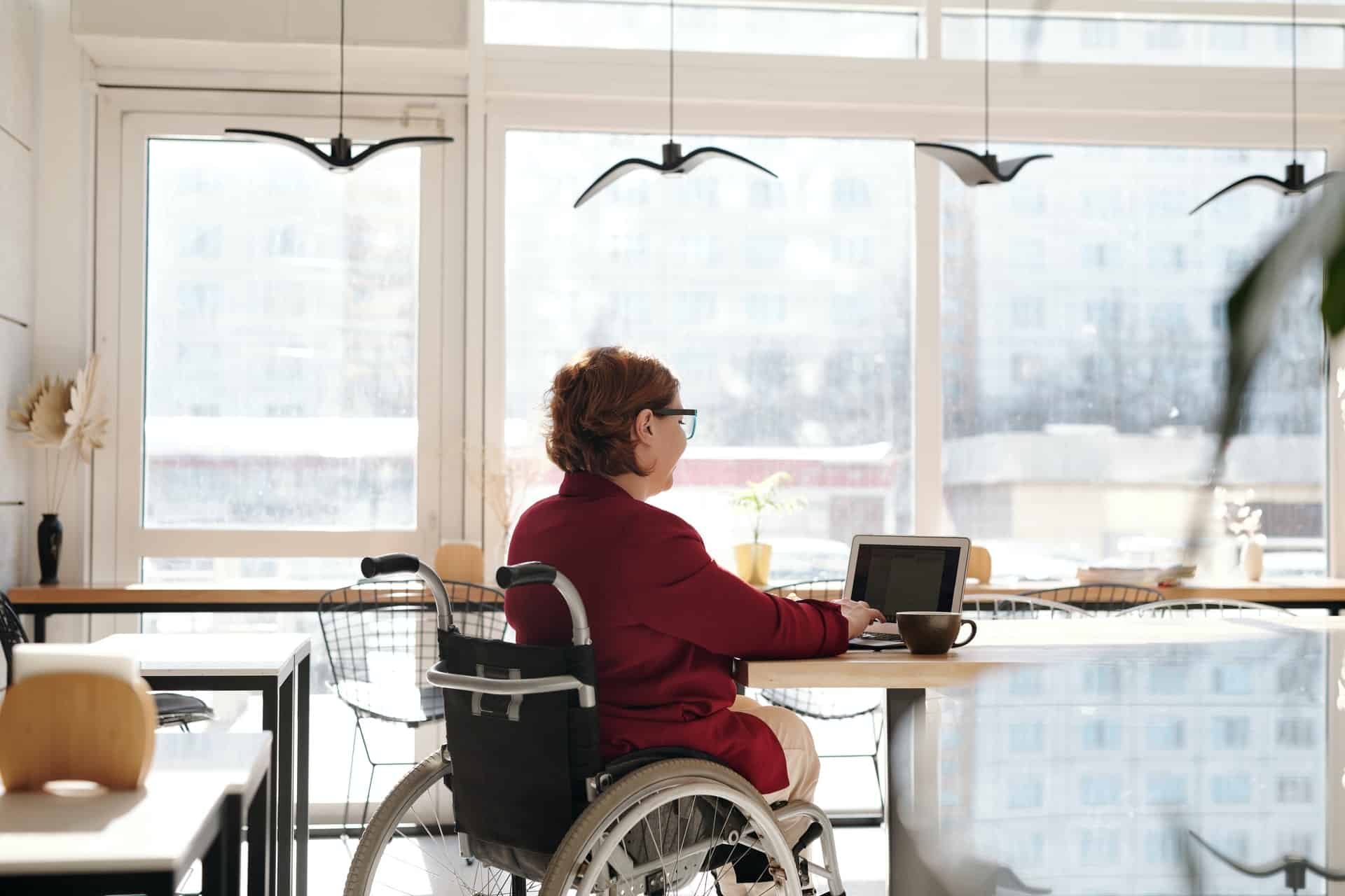 Person in wheelchair using laptop