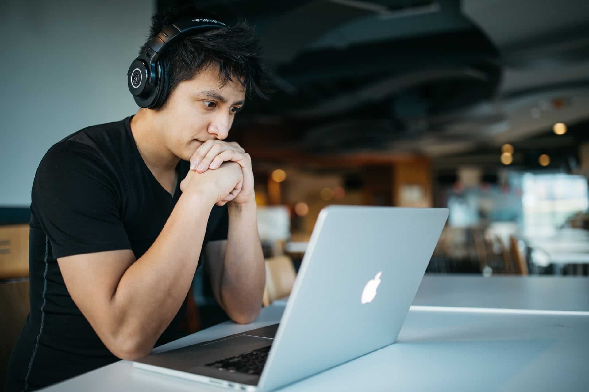 Man looking at laptop worried