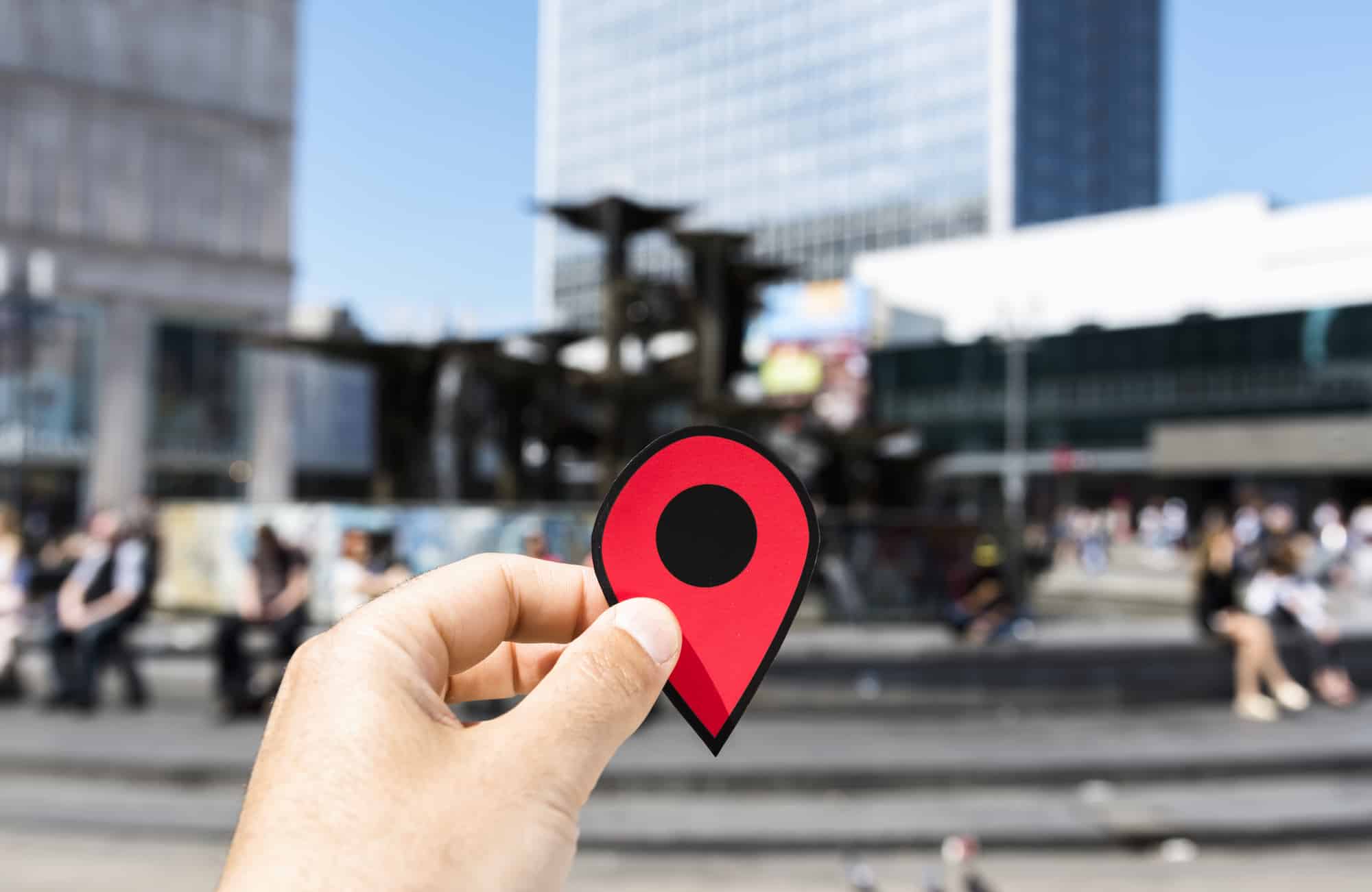 Person holding location pin