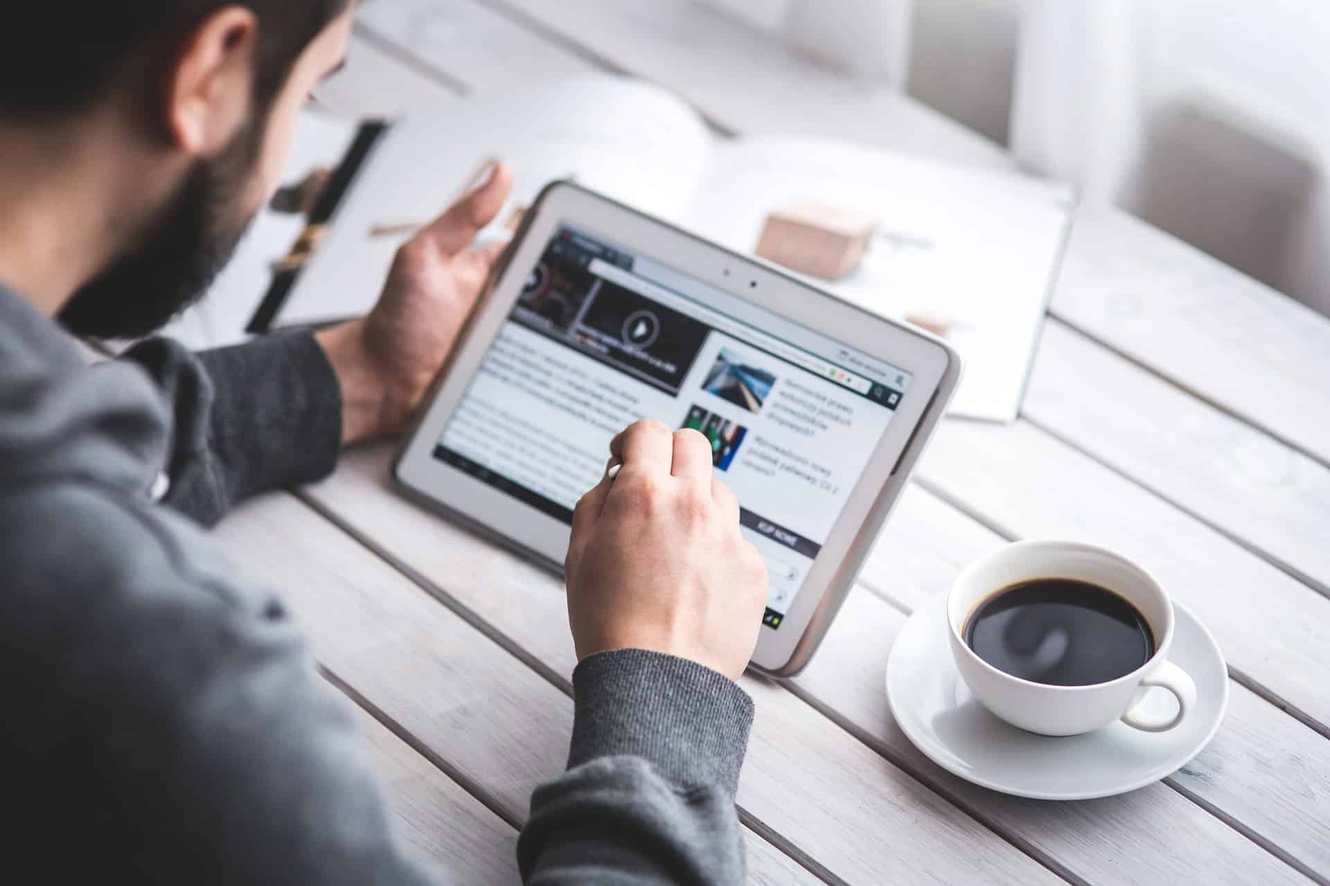 A man reading on his tablet.